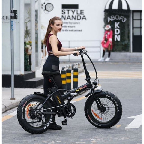 Black AddMotor Motan M150 - Folding Fat Tire Electric Bike - with Female Rider in Street