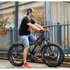 Image of AddMotor Motan M5800 - Fat Tire Electric Bike - Male Riding Down the Steet