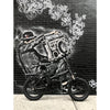 Image of Joulvert Playa Desert - Folding Electric Bike - parked in front of graffiti 
