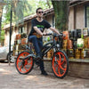 Image of Orange AddMotor HitHot H2 w/ MAG Wheel - Electric Mountain Bike - Riding Down the Street