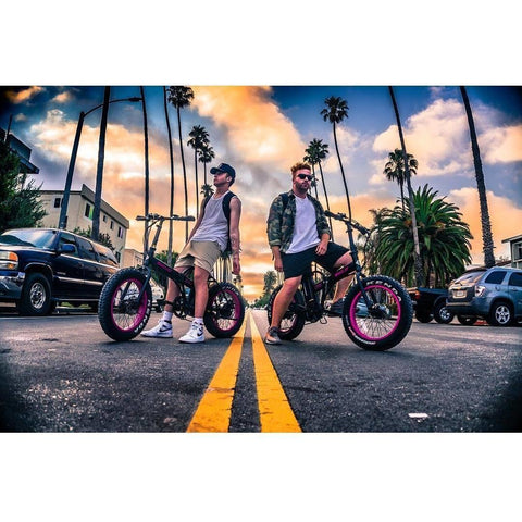 EMOJO Lynx - Fat Tire Folding Electric Bike - Two Riders in the middle of the street