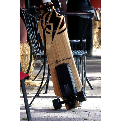 Atom Long Boards  H10 Electric Skateboard - Leaning Against a Chair