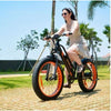 Image of Orange AddMotor Motan M450 - Fat Tire Electric Bike - Female Rider on Bricks